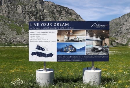 A sign board advertises property on sale at the Andermatt Swiss Alps resort in Andermatt