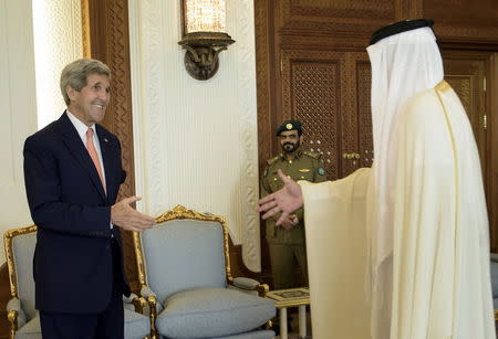 Qatar's Emir Sheikh Tamim bin Hamad al-Thani (R) greets U.S. Secretary of State John Kerry before their meeting at the Diwan Palace in Doha, August 3, 2015. REUTERS/Brendan Smialowski/Pool