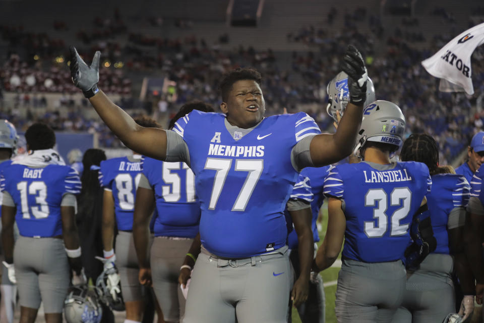 Memphis offensive lineman Kyndall McKenzie (77) hype up the home crowd during an NCAA college football game against Houston, Friday, Oct. 7, 2022, in Memphis, Tenn. (Patrick Lantrip/Daily Memphian via AP)