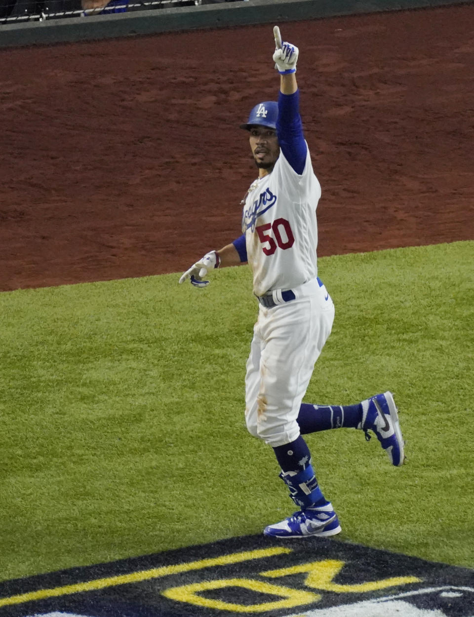 Los Angeles Dodgers' Mookie Betts celebrates a home run against the Tampa Bay Rays during the sixth inning in Game 1 of the baseball World Series Tuesday, Oct. 20, 2020, in Arlington, Texas. (AP Photo/Sue Ogrocki)