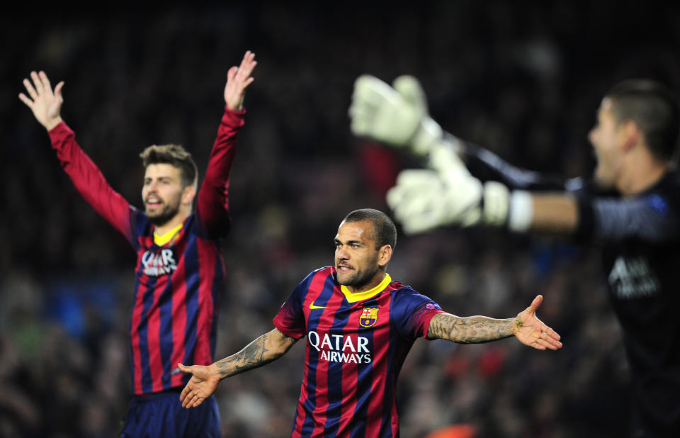 Barcelona's Gerard Pique, Daniel Alves and goalkeeper Victor Valdes, from left to right, gesture during a Champions League, round of 16, second leg, soccer match between FC Barcelona and Manchester City at the Camp Nou Stadium in Barcelona, Spain, Wednesday March 12, 2014. (AP Photo/Manu Fernandez)