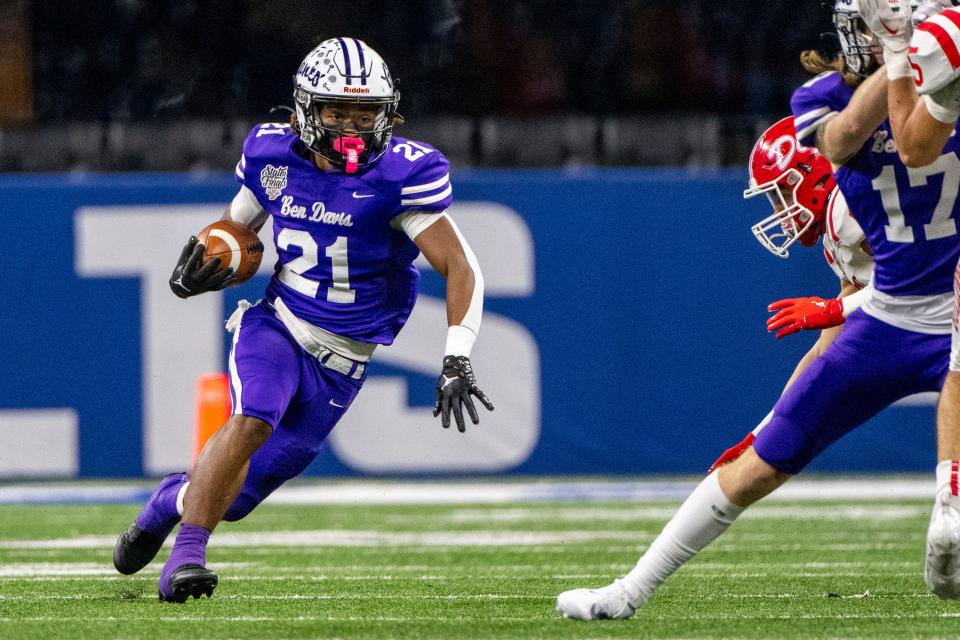 Ben Davis High School junior Alijah Price (21) makes a run during the first half of an IHSAA Class 6A State Championship football game against Crown Point High School, Saturday, Nov. 25, 2023, at Lucas Oil Stadium, in Indianapolis.