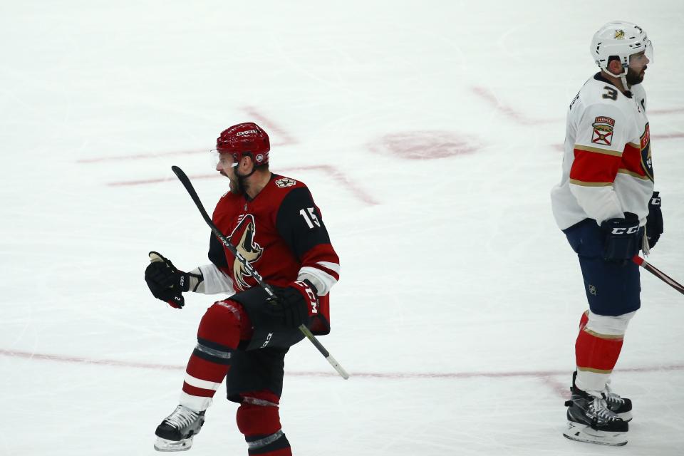 Arizona Coyotes center Brad Richardson (15) celebrates his goal as Florida Panthers defenseman Keith Yandle (3) skates past during the first period of an NHL hockey game Tuesday, Feb. 25, 2020, in Glendale, Ariz. (AP Photo/Ross D. Franklin)