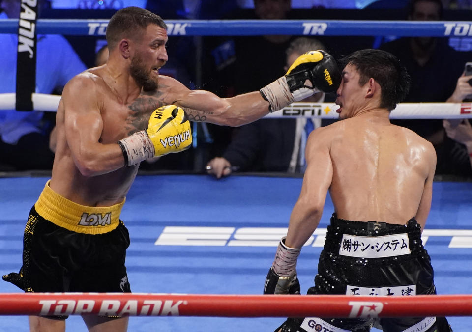 Vasiliy Lomachenko, of Ukraine, hits Masayoshi Nakatani, of Japan, during a lightweight bout Saturday, June 26, 2021, in Las Vegas. (AP Photo/John Locher)