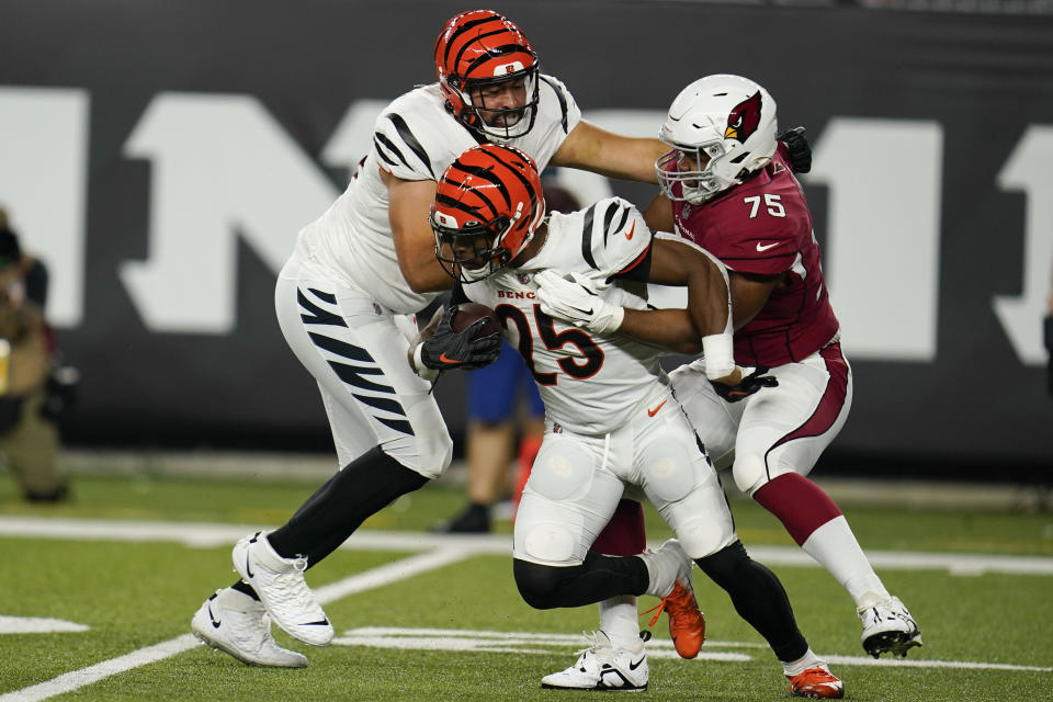 Cincinnati Bengals running back Chris Evans (25) tries to break free from Arizona Cardinals defensive tackle Manny Jones (75) during the second half of an NFL football preseason game in Cincinnati, Friday, Aug. 12, 2022. (AP Photo/Michael Conroy)