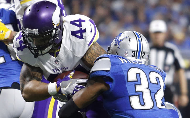 Nov 24, 2016; Detroit, MI, USA; Minnesota Vikings running back Matt Asiata (44) breaks a tackle from Detroit Lions strong safety Tavon Wilson (32) for a touchdown run during the first quarter at Ford Field.