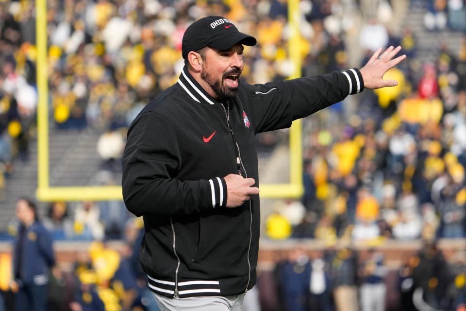 Nov 25, 2023; Ann Arbor, Michigan, USA; Ohio State Buckeyes head coach Ryan Day leads his team in warm-ups prior to the NCAA football game against the Michigan Wolverines at Michigan Stadium.