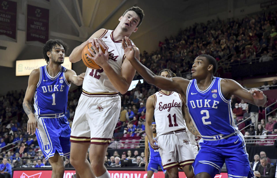 Boston College's Quinten Post (12) grabs a rebound under Duke's net during the first half of an NCAA college basketball game, Saturday, Jan. 7, 2023, in Boston. (AP Photo/Mark Stockwell)