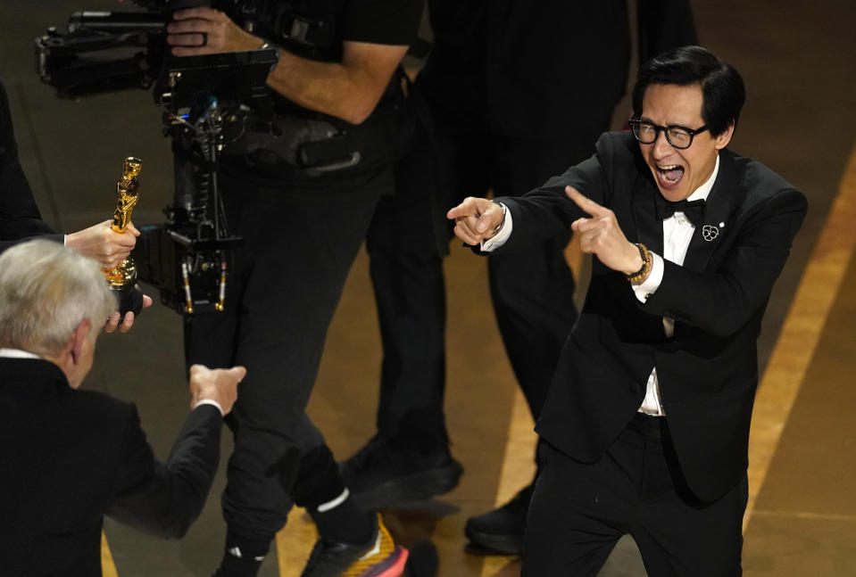 Ke Huy Quan, right, a cast member in "Everything Everywhere All at Once," gestures to presenter Harrison Ford after the film won the award for best picture during the 95th Academy Awards, Sunday, March 12, 2023, at the Dolby Theatre in Los Angeles. Quan and Ford were fellow cast members in the 1984 film "Indiana Jones and the Temple of Doom." (AP Photo/Chris Pizzello)