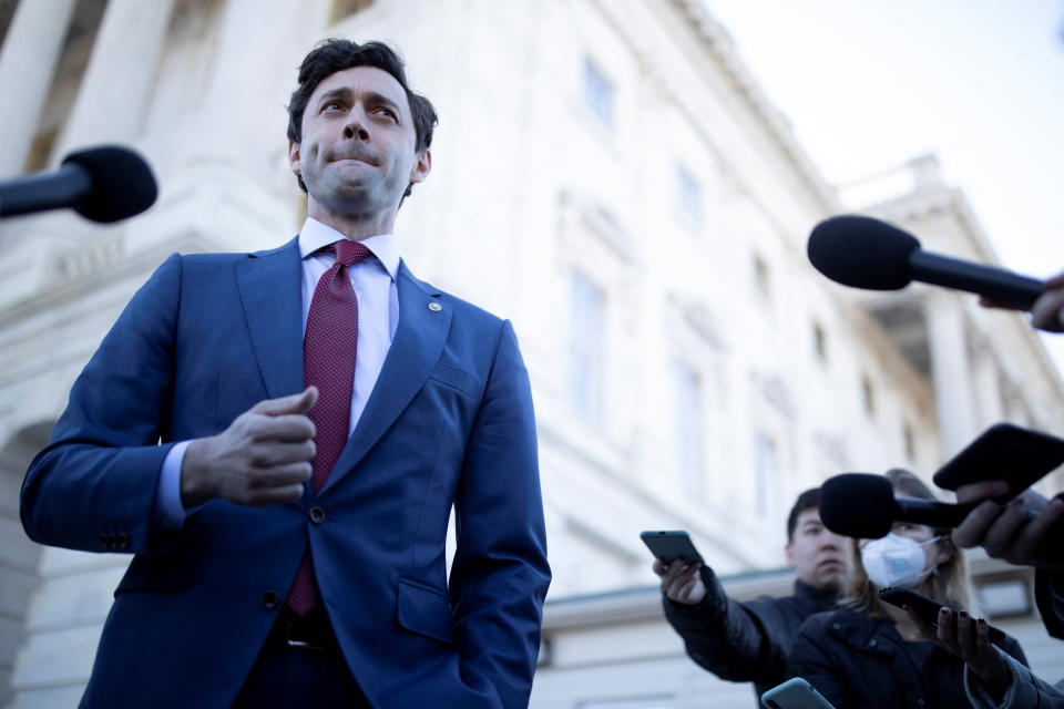 Senator Jon Ossoff (D-GA) speaks to journalists on his effort to ban Congressional stock trading among members, on Capitol Hill in Washington, U.S., February 9, 2022. REUTERS/Tom Brenner