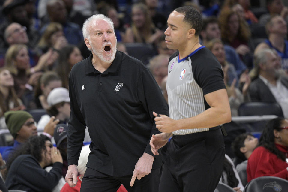 San Antonio Spurs coach Gregg Popovich, left, argues with official Jonathan Sterling during the first half of the team's NBA basketball game against the Orlando Magic, Friday, Dec. 23, 2022, in Orlando, Fla. (AP Photo/Phelan M. Ebenhack)