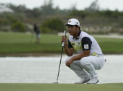 Tom Kim, of South Korea, studies his putt at the 18th green during the second round of the Hero World Challenge PGA Tour at the Albany Golf Club, in New Providence, Bahamas, Friday, Dec. 2, 2022. (AP Photo/Fernando Llano)