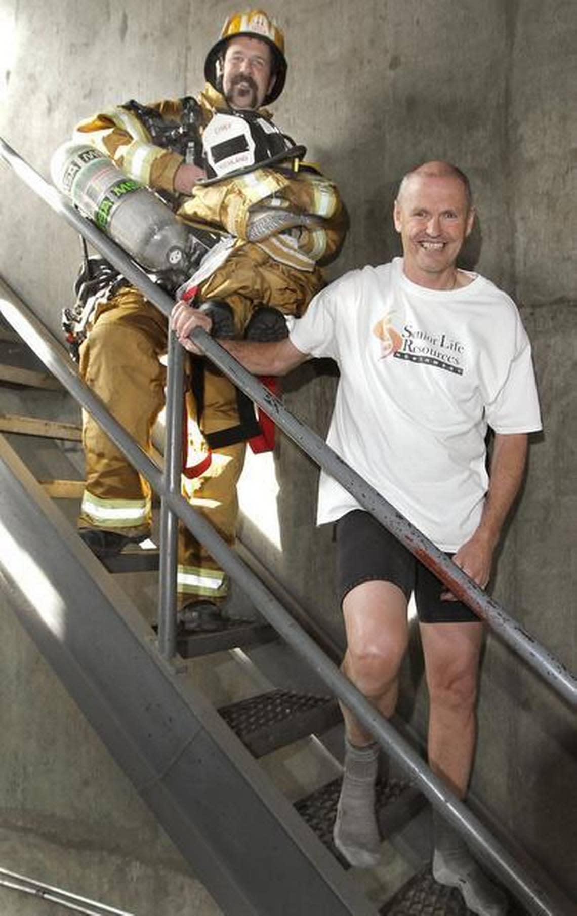 March 8, 2015 - Grant Baynes, recently retired Richland fire chief, plans to strip off his heavy firefighting gear and walk away wearing only shorts and a T-shirt after completing the stair climb competition in Seattle. Richland Fire Capt. Damon Bryan, left, followed him down carrying the 60 pounds of equipment. Baynes stripped down to pay tribute to his friend, the late Richland fire Capt. Charlie Bryan, Damon’s father, who often joked about retiring from the fire service wearing only his shorts.