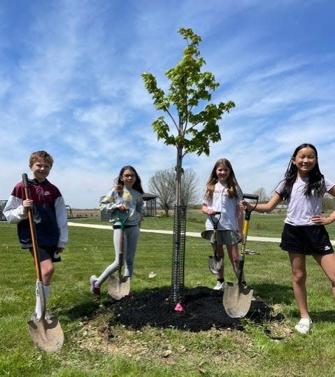 From left, Granville Intermediate School first graders Gabriel Wasko, Charlotte Blackstone, Piper Gorney and Emma Wei with a red maple tree planted at the school in honor of Arbor Day.