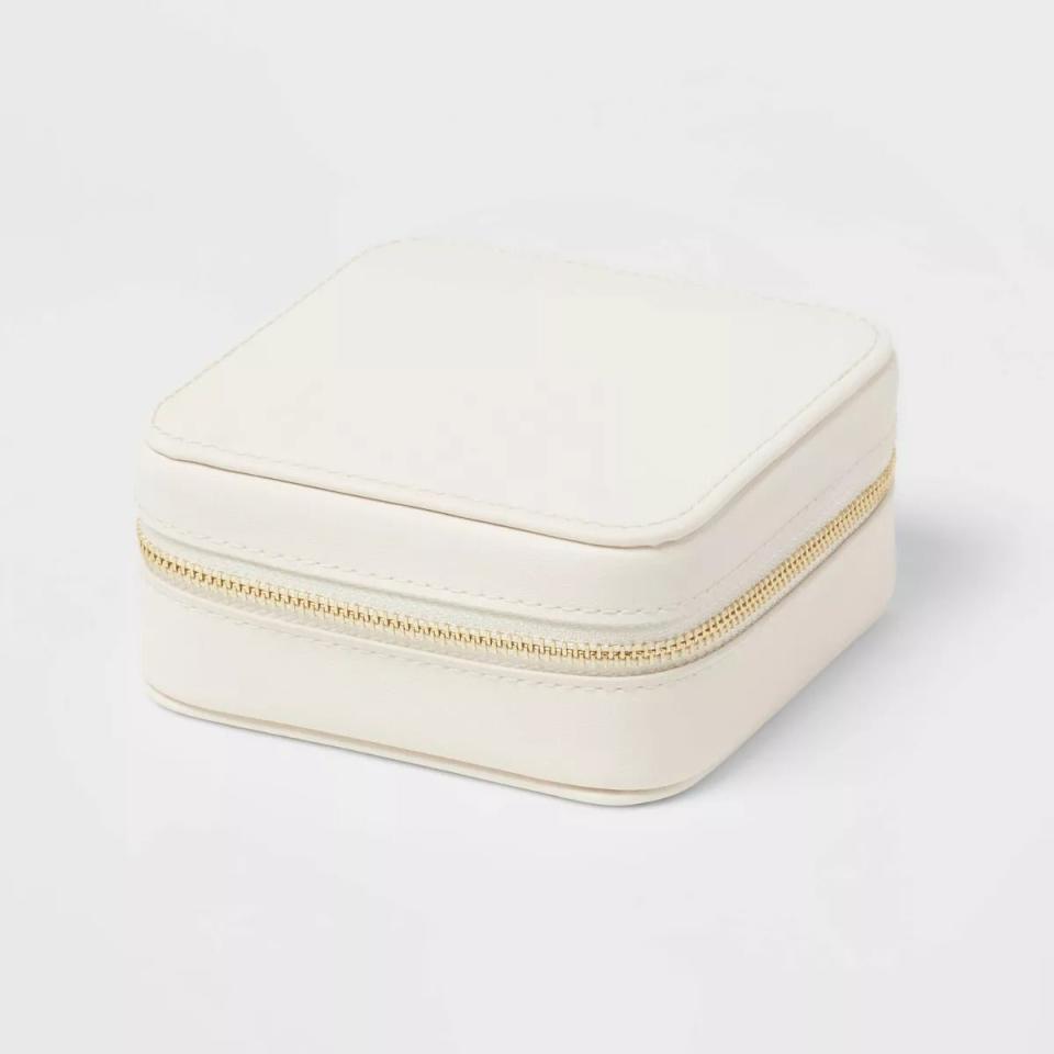 Small square-shaped white jewelry case with zipper closure