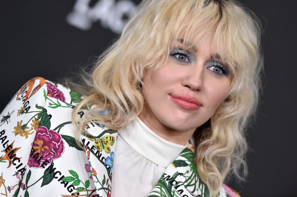 Miley Cyrus appears to channel god mother Dolly Parton in a new shoot for Forbes. Pictured in November 2021. (Getty Images)