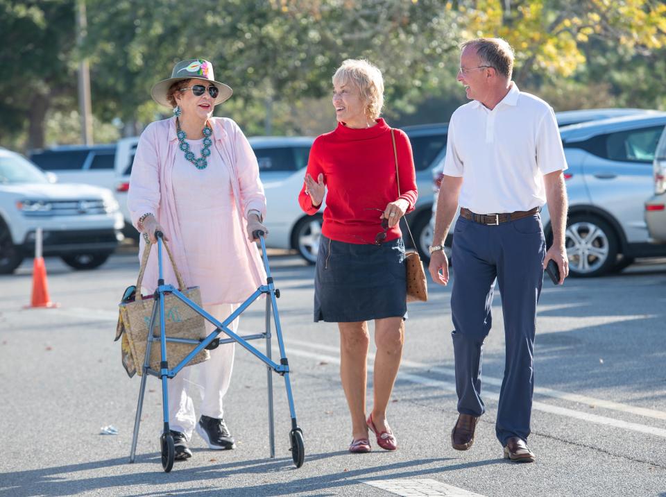 From left, Susan Haselton-Barr, Gulf Breeze Mayor Cherry Fitch and co-campaign manager Gary Michaels chat while heading to the polls on Election Day at the Gulf Breeze Community Center.