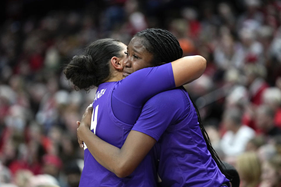 James Madison guard Kobe King-Hawea, left, and Kiki Jefferson, right, hug in the second half of a first-round women's college basketball game against Ohio State in the NCAA Tournament Saturday, March 18, 2023, in Columbus, Ohio. Ohio State won 80-66. (AP Photo/Paul Sancya)