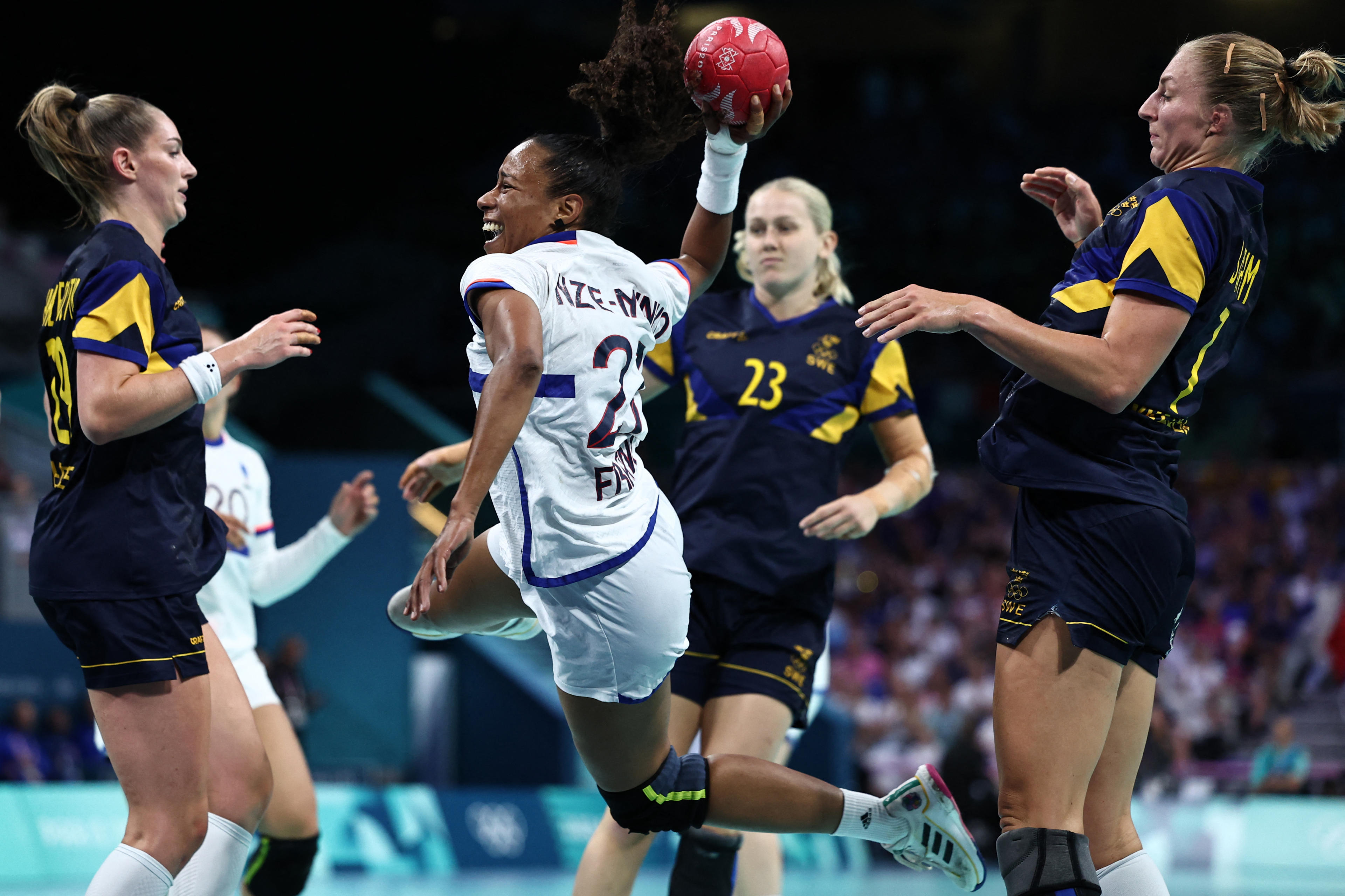 France's left back #27 Estelle Nze Minko (2ndL) shoots during the women's semi-final handball match between Sweden and France of the Paris 2024 Olympic Games, at the Pierre-Mauroy stadium in Villeneuve-d'Ascq, northern France, on August 8, 2024. (Sameer Al-Doumy/AFP/Getty Images)