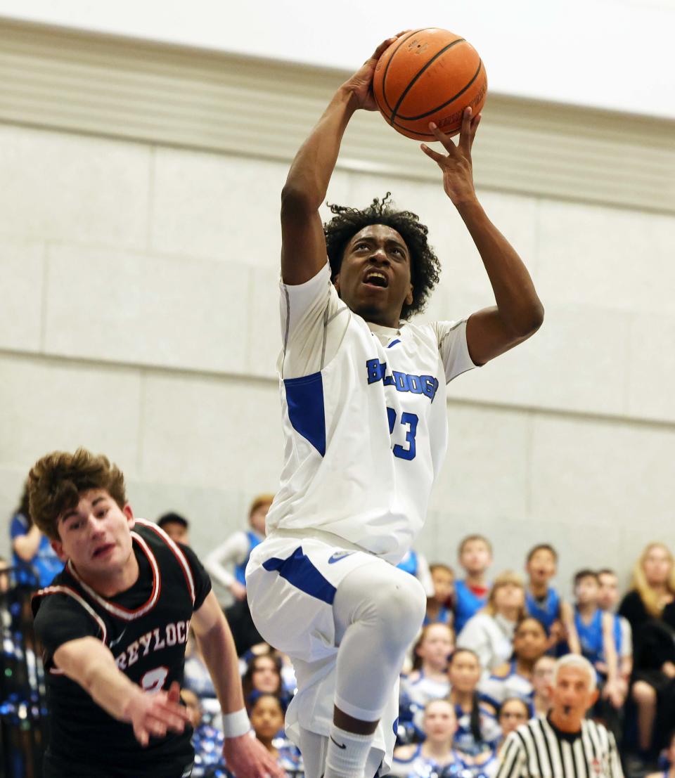 Holbrook's Armani Perkins goes past Mount Greylock's Seamus Barnes for the basket during a game on Friday, March 10, 2023.