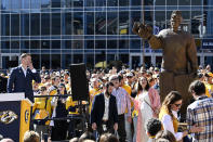 Former Nashville Predators goaltender Pekka Rinne, left, looks at his statue as he speaks during an unveiling ceremony before an NHL hockey game between the Nashville Predators and the Seattle Kraken, Saturday, March 25, 2023, in Nashville, Tenn. (AP Photo/Mark Zaleski)