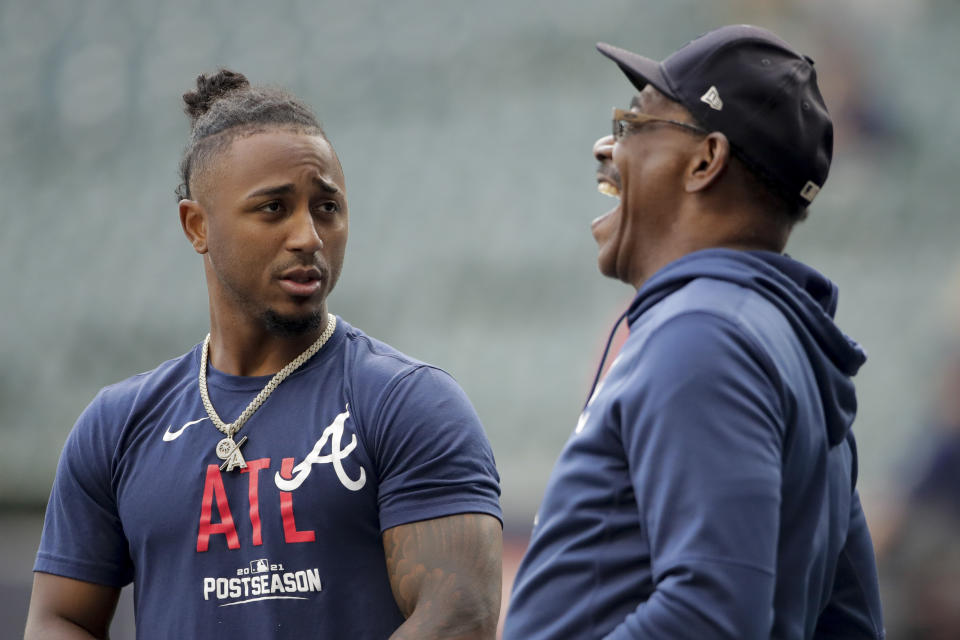 Atlanta Braves second baseman Ozzie Albies talks with third base coach Ron Washington before Game 2 of baseball's National League Divisional Series against the Milwaukee Brewers Saturday, Oct. 9, 2021, in Milwaukee. (AP Photo/Aaron Gash)