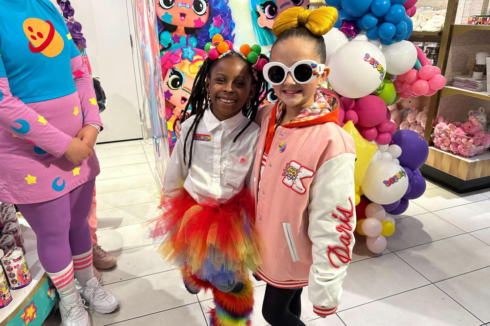 Taylen Biggs, right, and Nubia Williams pose at an FAO Schwarz store where toy company Cepia LLC launched its new fashion doll line called Decora Girlz on March 2, 2024 in New York. Cepia, which is based in St. Louis, Missouri, began investing in TikTok in 2019. (AP Photo/Anne D'Innocenzio)