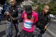 Riot police detain a suspect during an operation after violent clashes between drug gangs in Rocinha slum in Rio de Janeiro, Brazil, September 22, 2017. REUTERS/Bruno Kelly