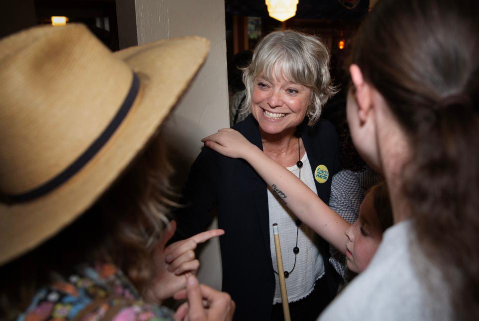 Eugene mayoral candidate Kaarin Knudson, center, celebrates with family and supporters as early returns show her leading the race for mayor during a watch party at The Bier Stein in Eugene.