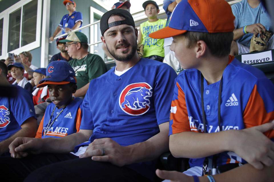 Chicago Cubs' Kris Bryant, center, talks with between Bowling Green, Kentucky's Grayson Newman, right, and Sol Guyer, left, in the stands at Volunteer Stadium during an International pool play baseball game at the Little League World Series tournament in South Williamsport, Pa., Sunday, Aug. 18, 2019. (AP Photo/Tom E. Puskar)