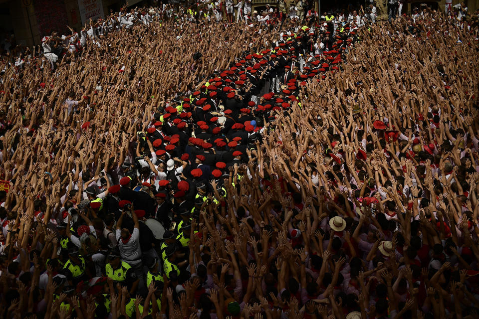 <p>A municipal band prepares while revelers hold up neckties during the launching of the <em>chupinazo</em> rocket to celebrate the official opening of the 2017 San Fermín Fiesta. (Photo: Alvaro Barrientos/AP) </p>