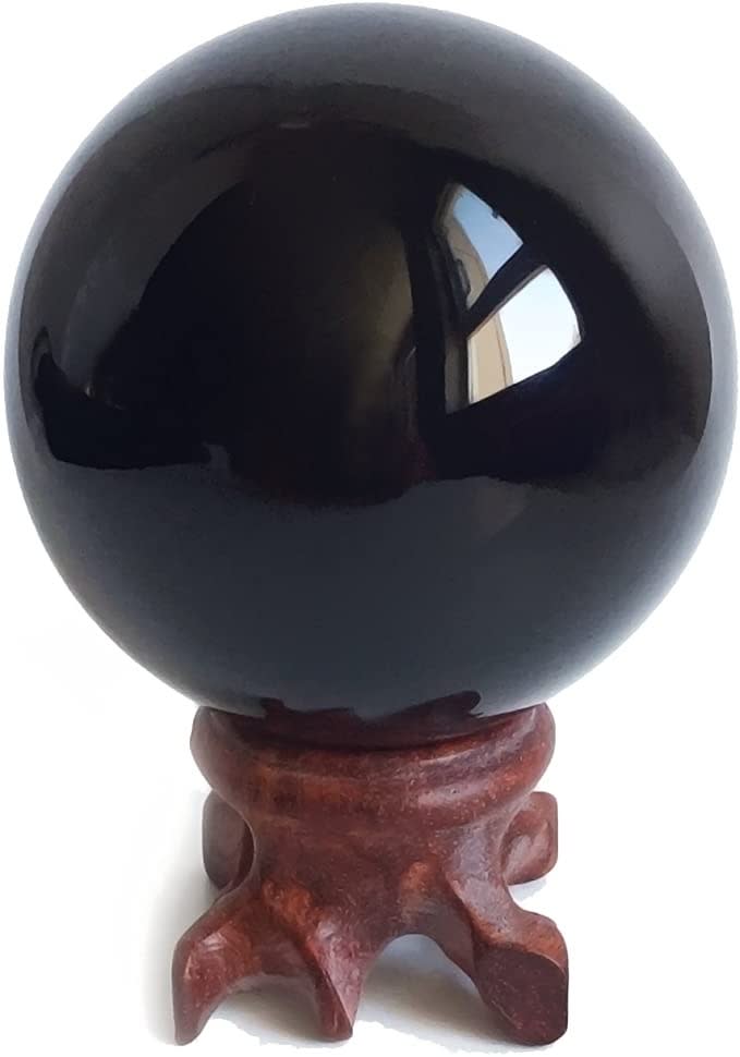black crystal ball and wooden base