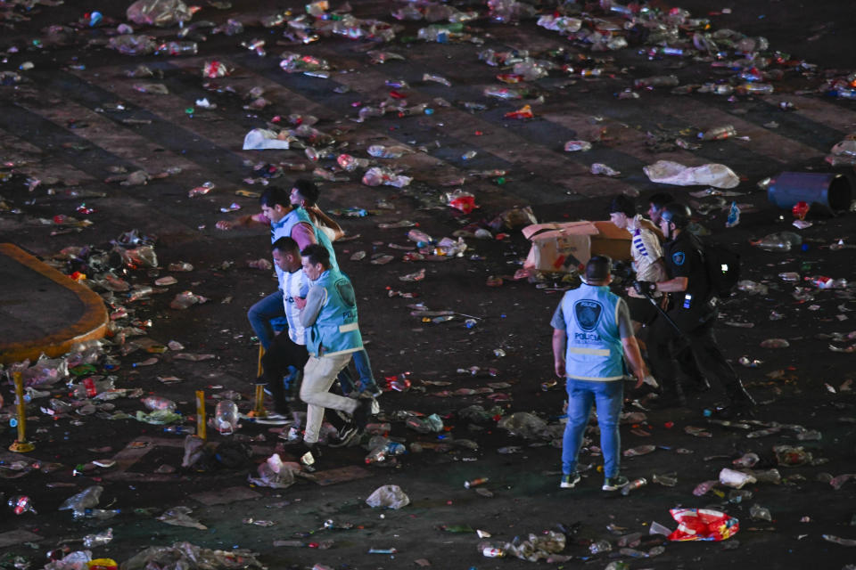 Police detain soccer fans after clashes around the capital's Obelisk where fans waited for hours for a homecoming parade for the players who won the World Cup in Buenos Aires, Argentina, Tuesday, Dec. 20, 2022. A parade to celebrate the champions was abruptly cut short Tuesday as millions of people poured onto thoroughfares, highways and overpasses in a chaotic attempt to catch a glimpse of the national team. (AP Photo/Gustavo Garello)