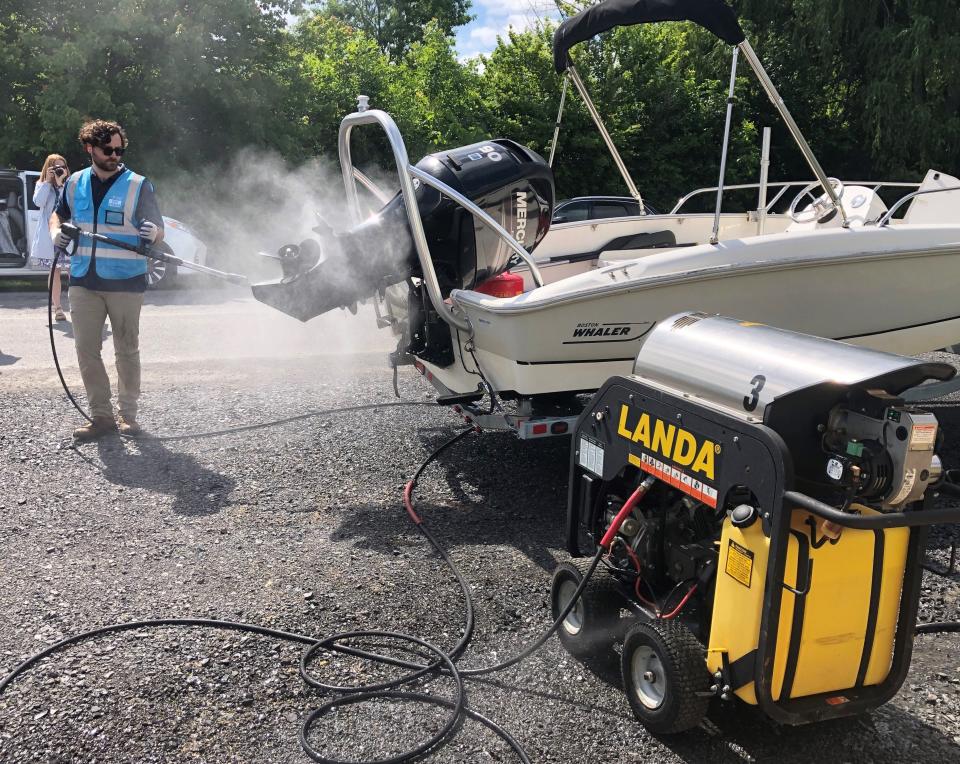 Caleb Truscott, coordinator of the watercraft steward program for the Finger Lakes Institute, puts the new boat-washing station at the Canandaigua Lake State Marine Park to good use.