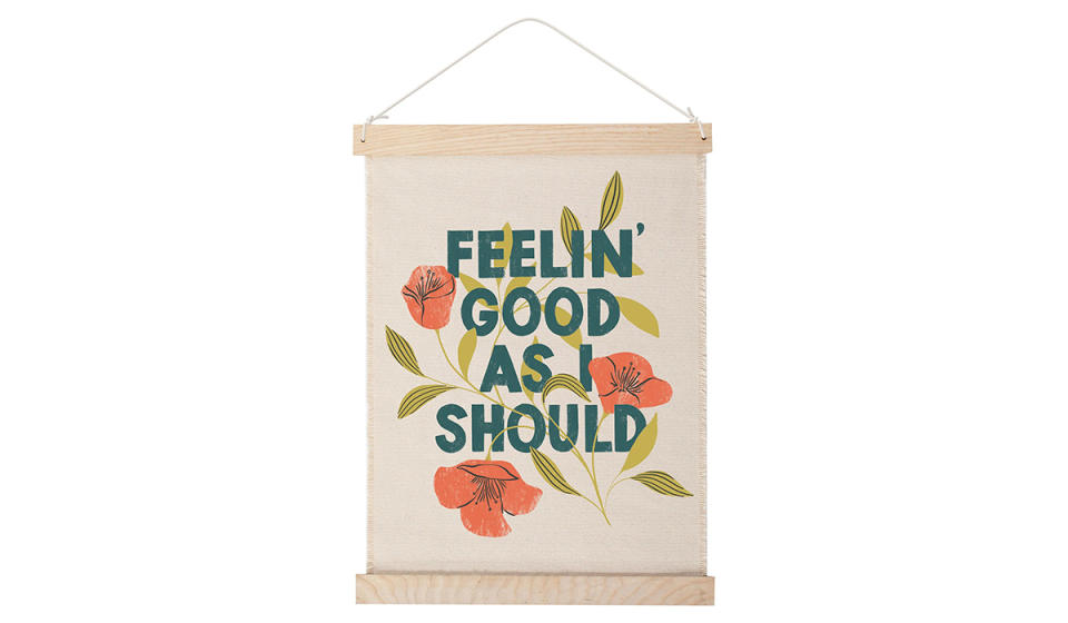 Wall hanging with illustrated poppies and text that says 