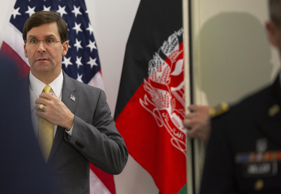 U.S. Secretary for Defense Mark Esper, left, prepares to greet Afghan Defense Minister Asadullah Khalid prior to a meeting at NATO headquarters in Brussels, Thursday, Feb. 13, 2020. NATO ministers, in a second day of meetings, will discuss building stability in the Middle East, the Alliance's support for Afghanistan and challenges posed by Russia's missile systems. (AP Photo/Virginia Mayo, Pool)