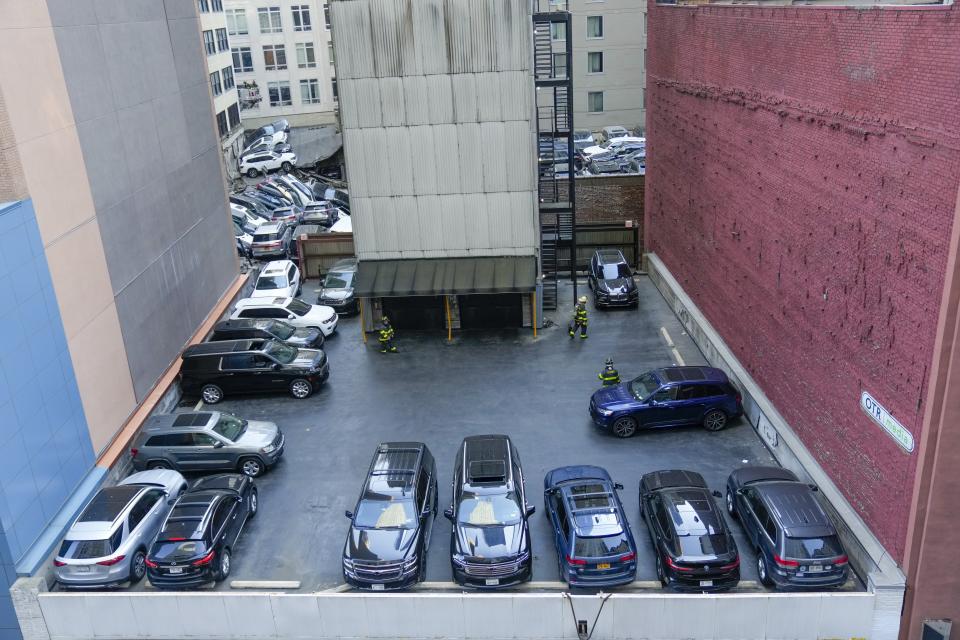 Firefighters are seen working at the scene of a partial collapse of a parking garage in the Financial District of New York, Tuesday, April 18, 2023. (AP Photo/Mary Altaffer)