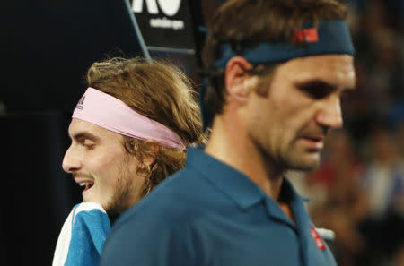 Tennis - Australian Open - Fourth Round - Melbourne Park, Melbourne, Australia, January 20, 2019. Switzerland’s Roger Federer and Greece’s Stefanos Tsitsipas during the match. REUTERS/Edgar Su