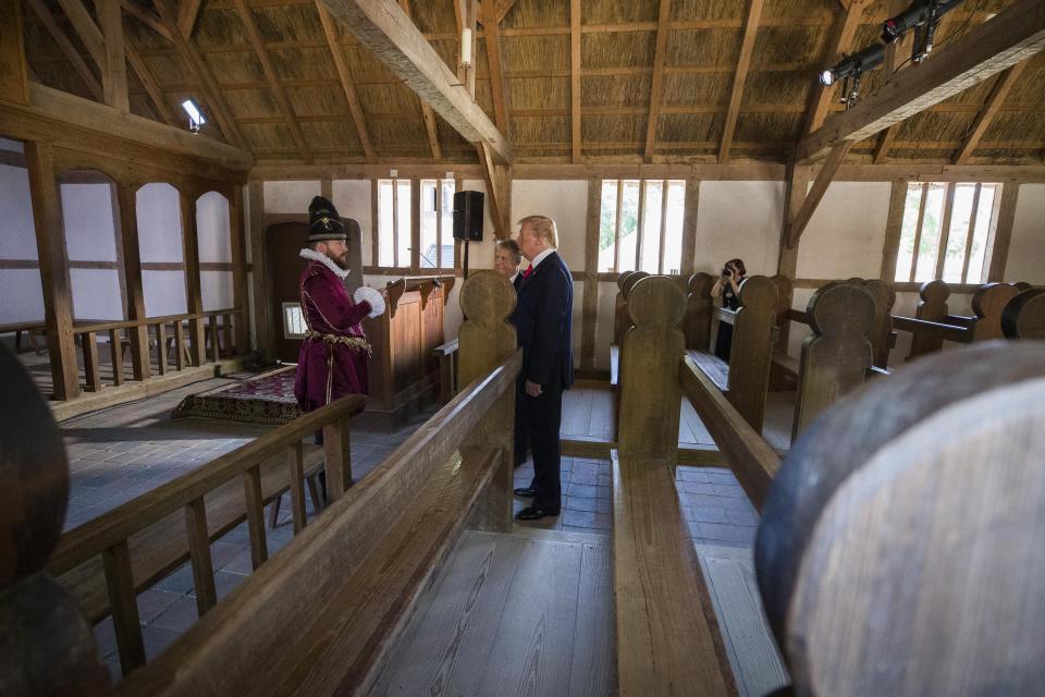 President Donald Trump tours the old Jamestown Settlement accompanied by Jamestown-Yorktown Foundation executive director Philip Emerson, center, Tuesday, July 29, 2019, in Jamestown, Va. (AP Photo/Alex Brandon)