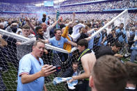 Manchester City fans celebrate after the English Premier League soccer match between Manchester City and Aston Villa at the Etihad Stadium in Manchester, England, Sunday, May 22, 2022. Manchester City won the match against Aston Villa and secured the 2022 Premier League title. (AP Photo/Dave Thompson)