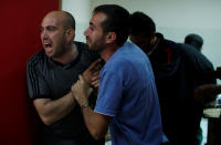 <p>Relatives of a Palestinian, who was killed during a protest at the Israel-Gaza border, react at a hospital in the northern Gaza Strip, May 14, 2018. (Photo: Mohammed Salem/Reuters) </p>