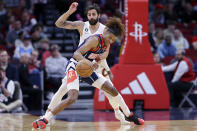 Houston Rockets guard Jalen Green, front, loses control of the ball under pressure from Cleveland Cavaliers guard Ricky Rubio, back, during the first half of an NBA basketball game Thursday, Jan. 26, 2023, in Houston. (AP Photo/Michael Wyke)