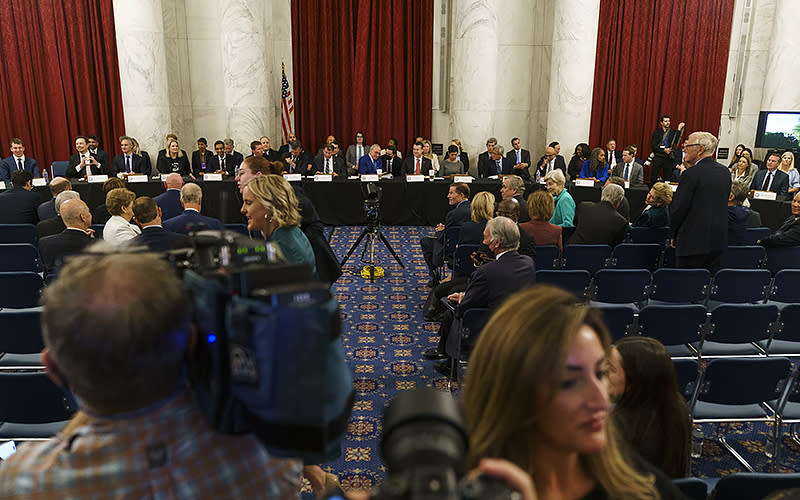 Senators and guest speakers are seen during a photo op before a Sept. 13 Senate Artificial Intelligence Insight Forum. <em>Greg Nash</em>