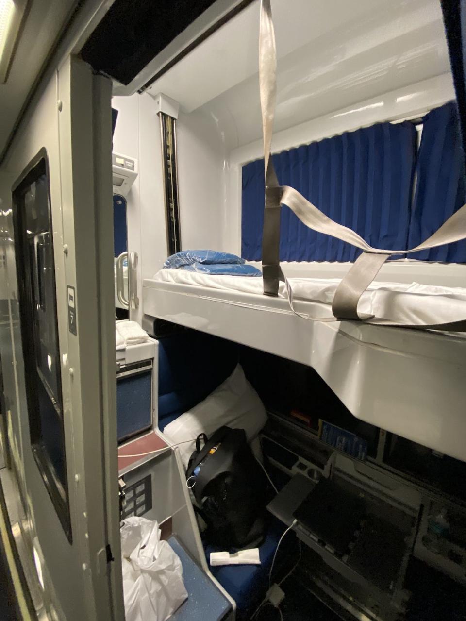 the bed in a sleeper car on an amtrak train