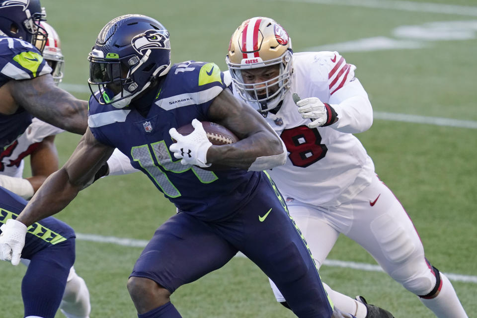 Seattle Seahawks wide receiver DK Metcalf (14) runs as San Francisco 49ers defensive end Jordan Willis, right, closes in during the second half of an NFL football game, Sunday, Nov. 1, 2020, in Seattle. (AP Photo/Elaine Thompson)