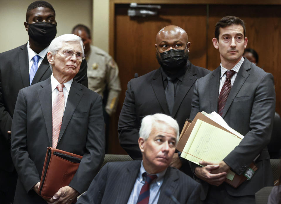 Former Memphis police officers Emmitt Martin III, back left, and Desmond Mills Jr., back center, stand with their attorneys in Judge James Jones Jr.'s courtroom involving the case of five Memphis police officers charged with fatally beating Tyre Nichols, Friday, Sept. 15, 2023, in Memphis, Tenn. (Mark Weber/Daily Memphian via AP)