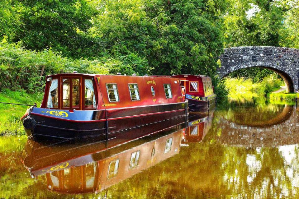 <p>Courtesy of Country Craft Narrowboats</p> One of Country Craft Narrowboats’ barges glides down the Monmouthshire & Brecon Canal, in Wales.