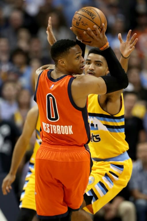 Russell Westbrook of the Oklahoma City Thunder looks for an outlet pass while being guarded by Gary Harris of the Denver Nuggets, at Pepsi Center in Denver, Colorado, on April 9, 2017