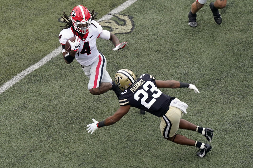 Vanderbilt cornerback Jaylen Mahoney (23) closes in on Georgia running back James Cook (4) in the first half of an NCAA college football game Saturday, Sept. 25, 2021, in Nashville, Tenn. (AP Photo/Mark Humphrey)