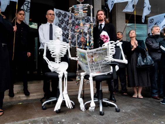 Demonstrators from the Extinction Rebellion climate environmental activist group take part in a protest outside the offices of UK newspapers including the Daily Mail at Northcliffe House in west London (AFP/Getty Images)